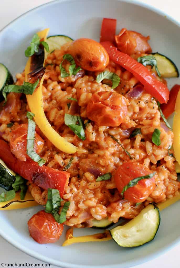 A rich and creamy risotto made with crushed tomatoes, served with chargrilled peppers, tomatoes and courgette to form a comforting and hearty vegetarian dinner.
