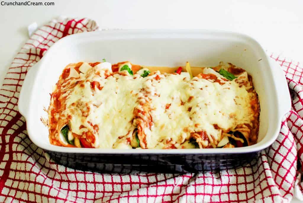 a dish of baked halloumi and spinach enchiladas