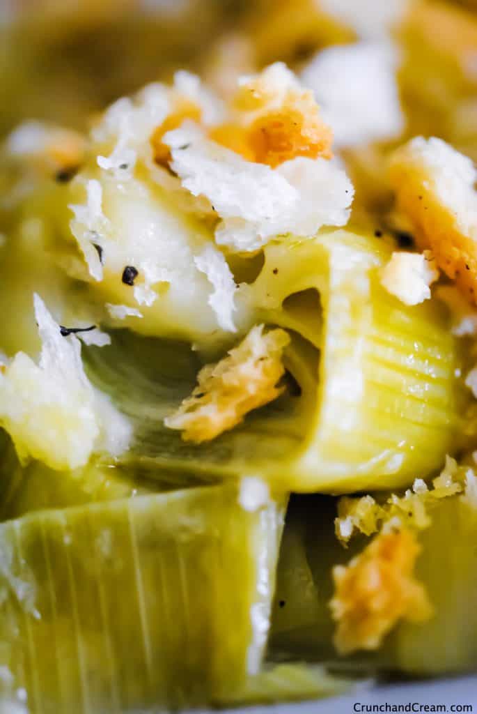 close-up of creamy leeks with a bechamel sauce and crispy breadcrumbs.