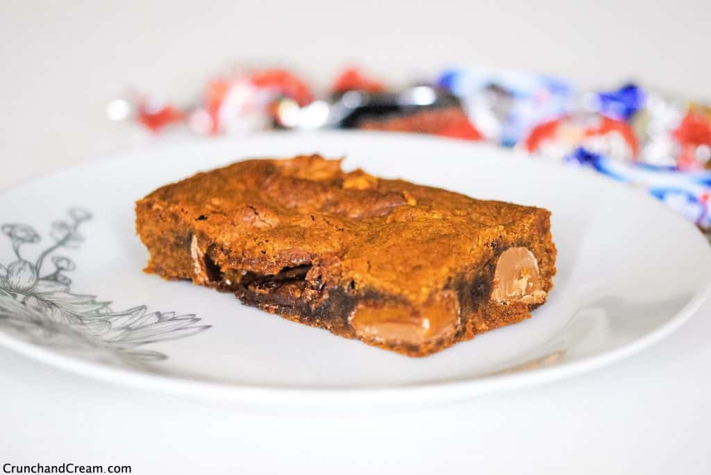 a blondie stuffed with mini chocolate bars on a plate