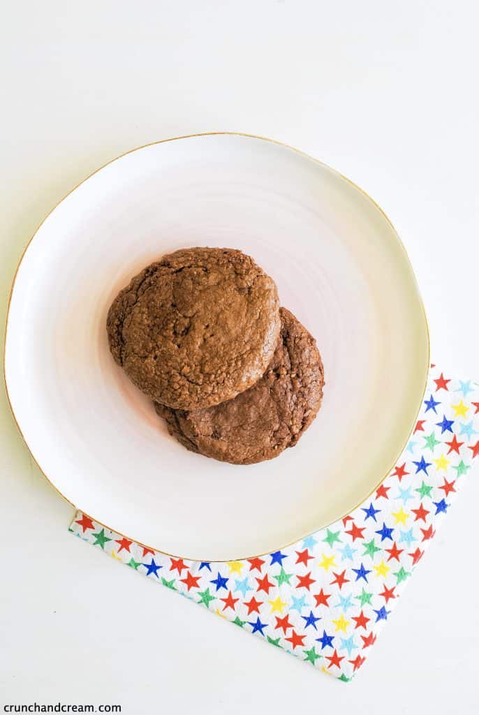 2 brown nutella cookies on a plate